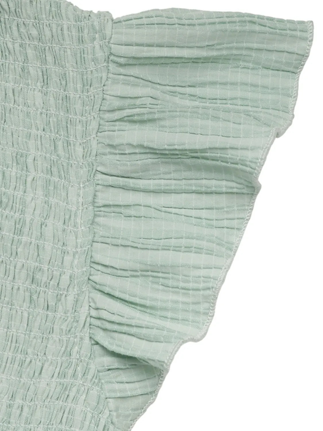 Light green ruffled fabric on a white background