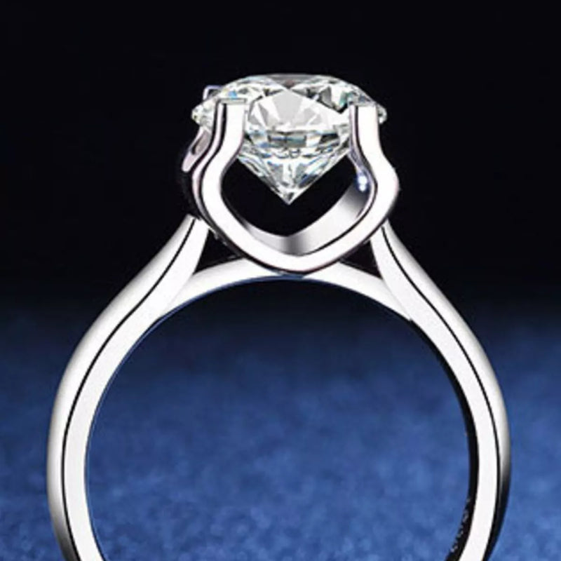 Silver ring with a large diamond on a dark background