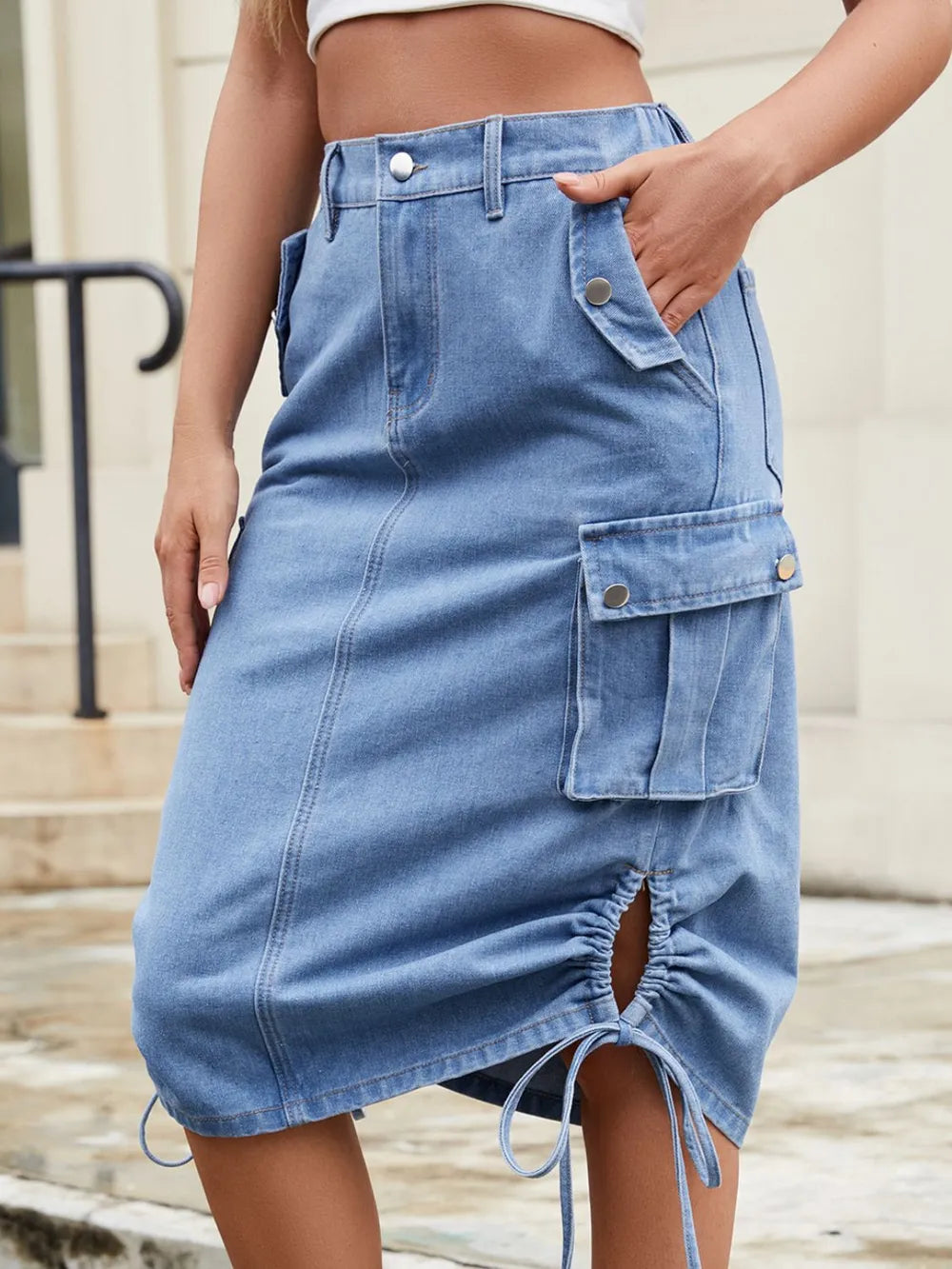 Blue denim skirt worn by a person with a neutral background