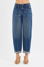 Blue jeans worn by a person on a white background