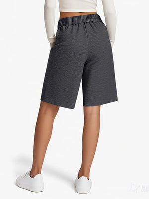 Person wearing gray shorts on a white background