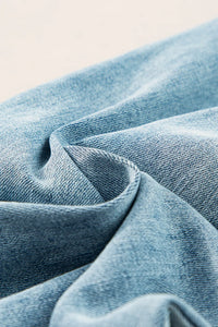 Close-up of blue denim fabric with a soft texture.