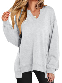 Gray oversized sweater worn by a person on a white background
