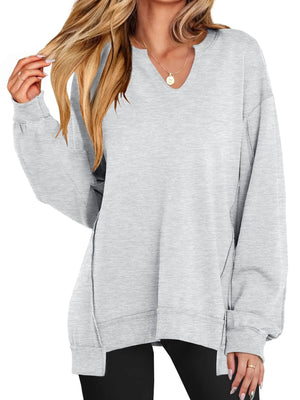 Gray oversized sweater worn by a person on a white background