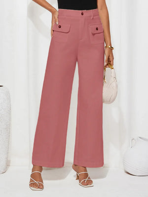 Person wearing pink wide-leg pants with a white background
