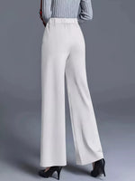 White wide-leg pants worn by a person on a gray background