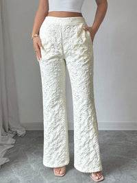 Person wearing textured white pants against a neutral background