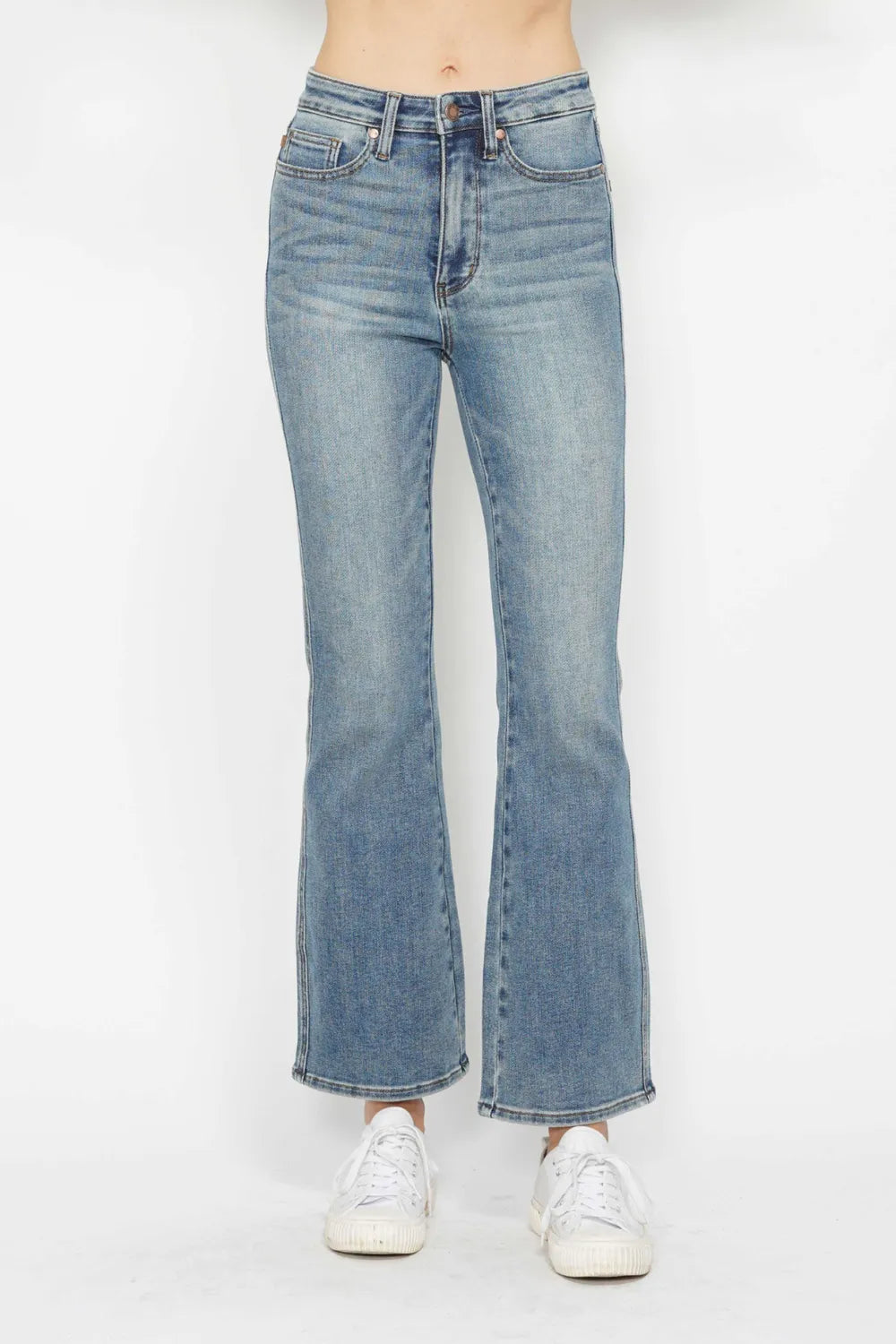 Light blue jeans worn by a person on a white background