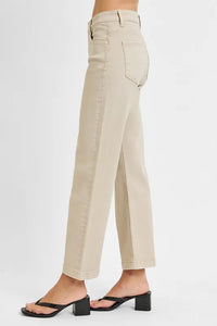 Beige pants worn by a person on a white background