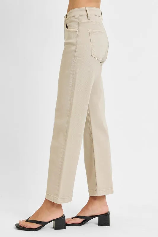 Beige pants worn by a person on a white background
