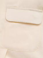 Close-up of a beige fabric with a pocket