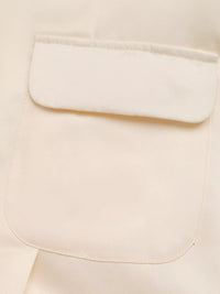 Close-up of a beige fabric with a pocket