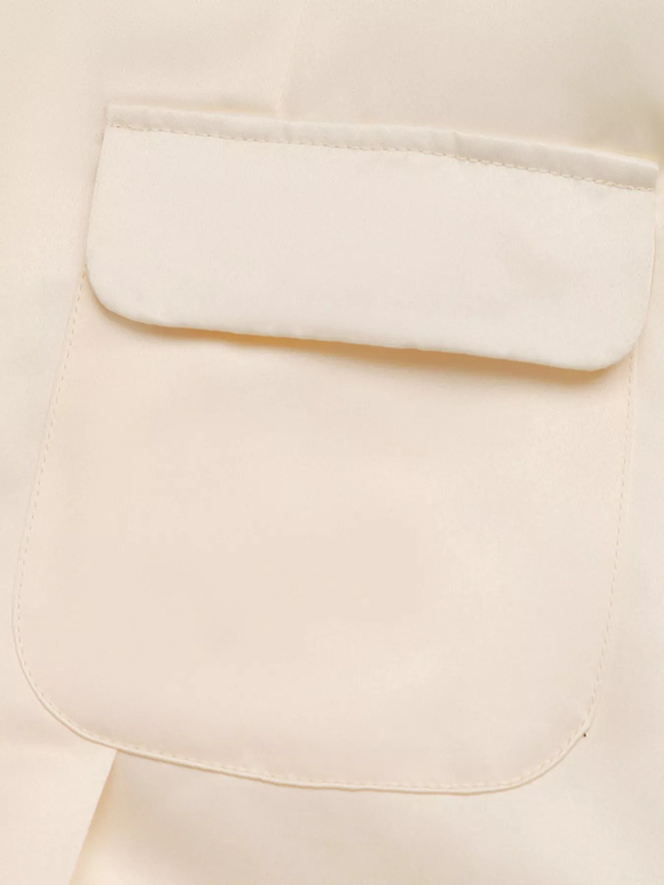 Close-up of a beige fabric with a pocket