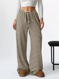 Striped pants worn by a person on a white background
