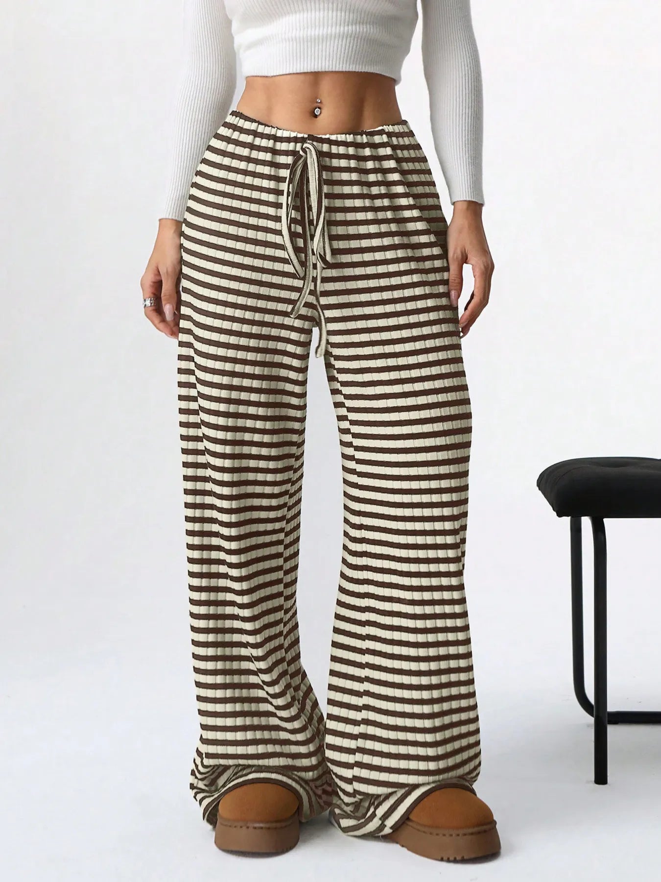 Striped pants worn by a person on a white background