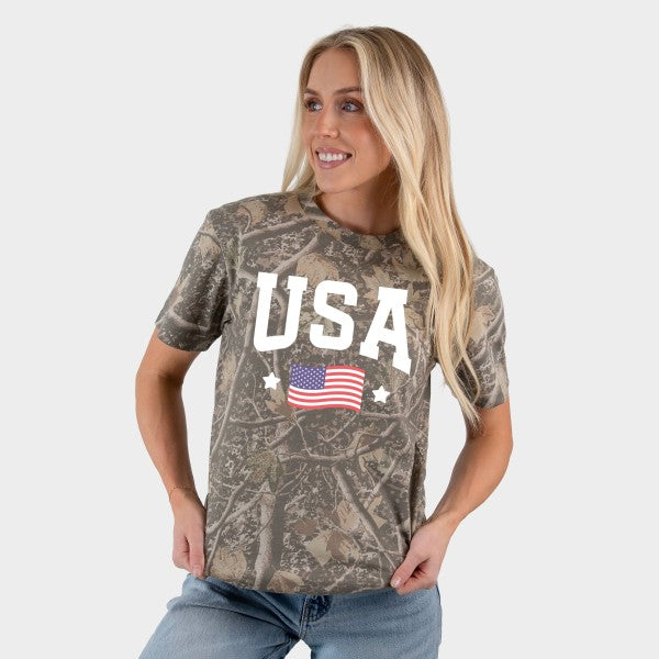 Woman wearing a camouflage t-shirt with 'USA' and an American flag design on a plain background