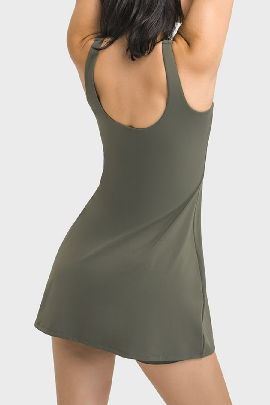 Green dress worn by a person on a white background