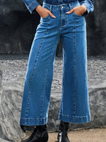 Person wearing blue jeans with a blurred background