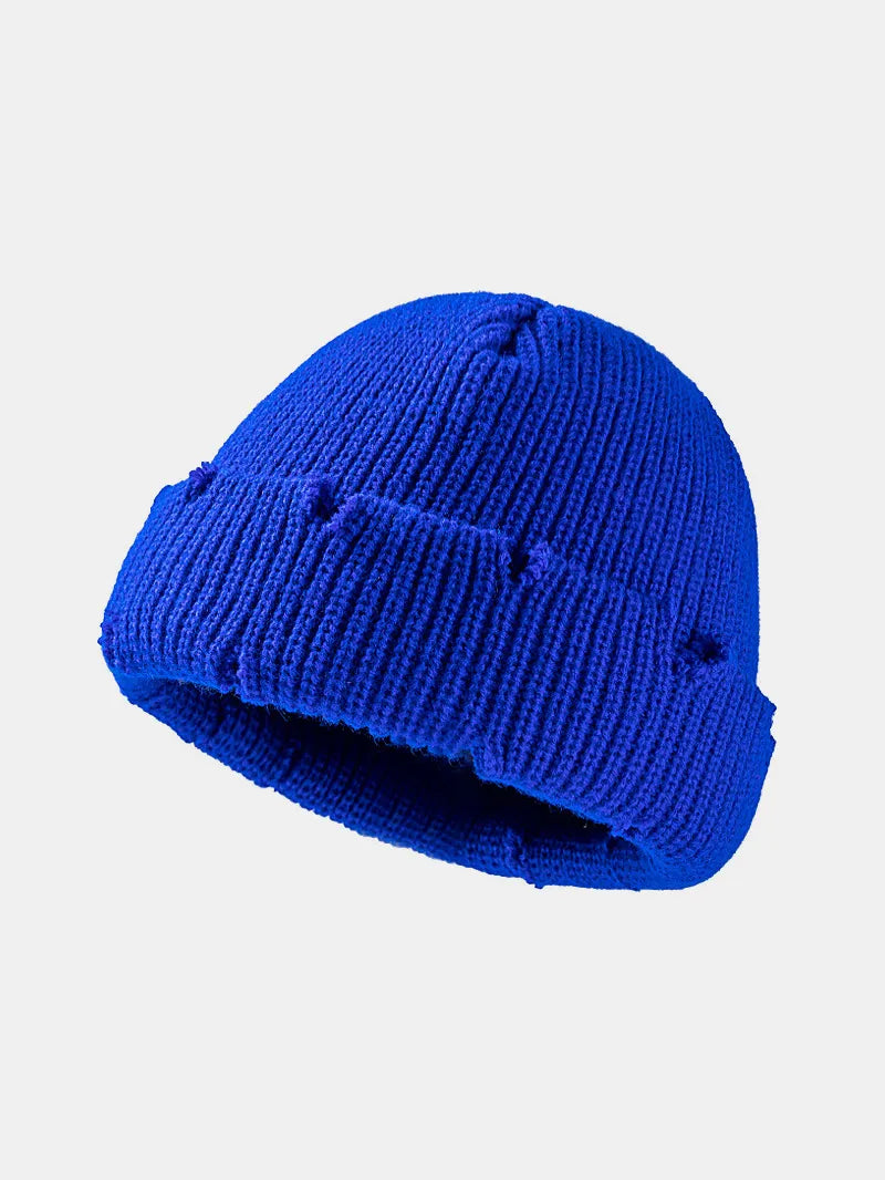 Blue knit beanie on a light gray background