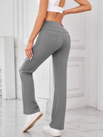 Person wearing gray pants in a minimalistic indoor setting