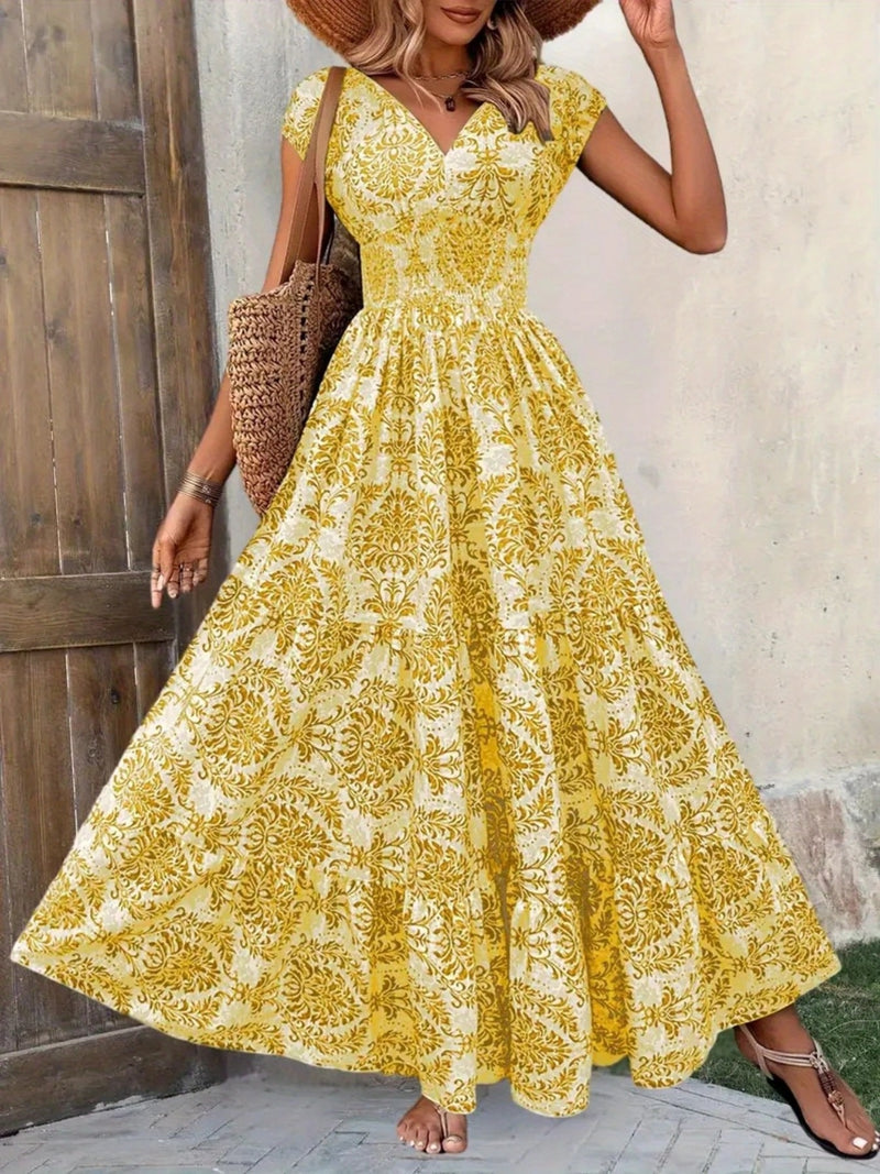 Woman wearing a yellow floral dress standing against a wooden door.