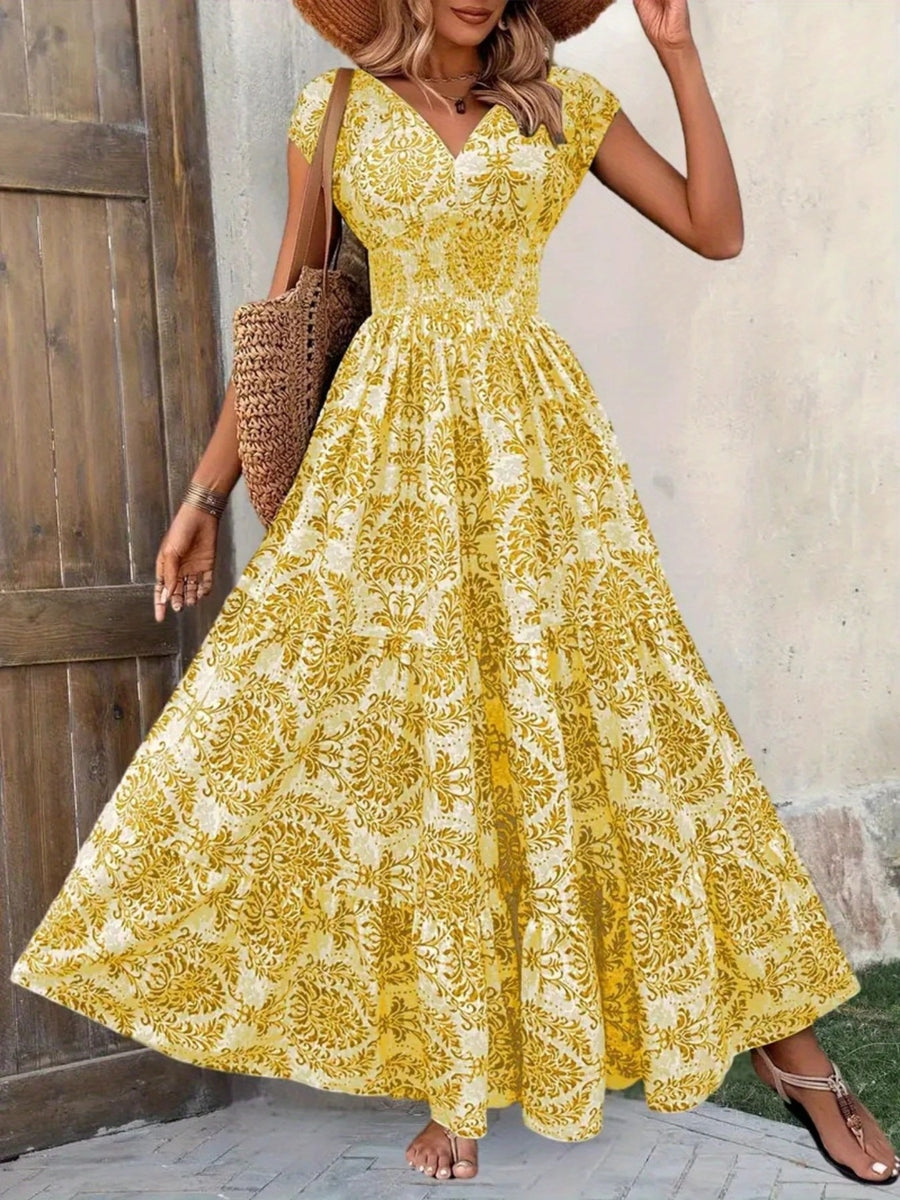 Woman wearing a yellow floral dress standing against a wooden door.