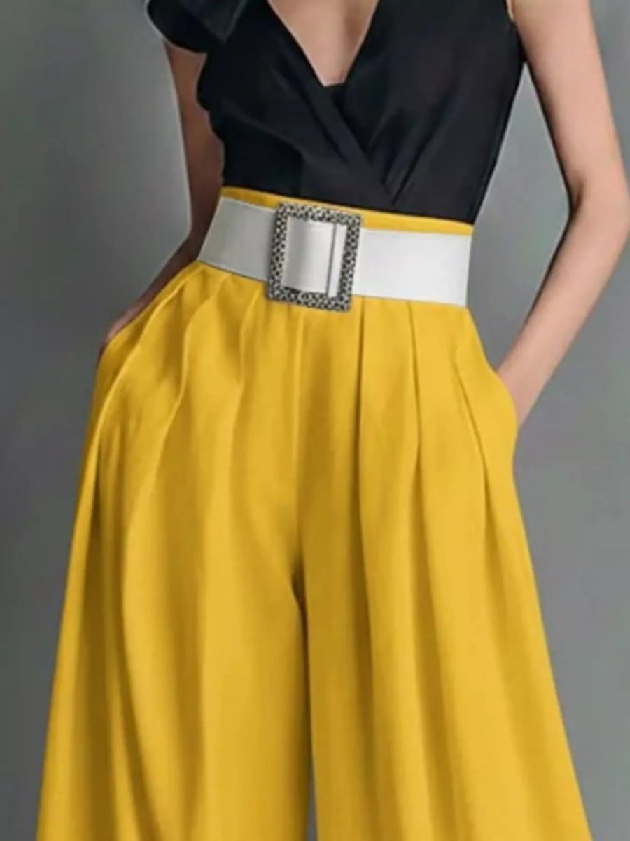 Yellow pants with a decorative belt on a gray background