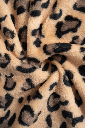Close-up of leopard print fabric with beige background