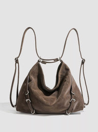 Brown leather handbag with drawstring on a light gray background