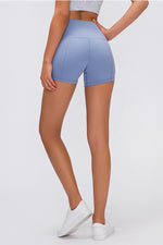 Person wearing light blue athletic shorts on a white background