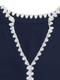 Navy blue garment with white lace trim on a plain background