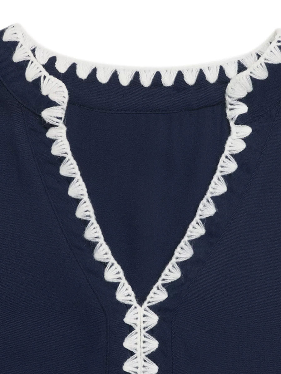Navy blue garment with white lace trim on a plain background