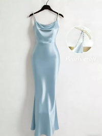 Light blue dress on a hanger against a white background