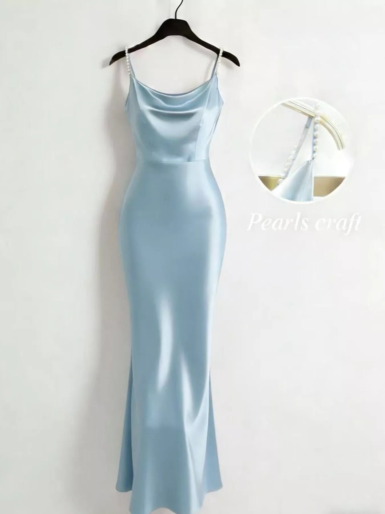 Light blue dress on a hanger against a white background