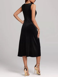 Black sleeveless dress worn by a model on a plain background