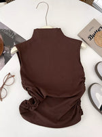 Brown sleeveless top on a hanger with a white background