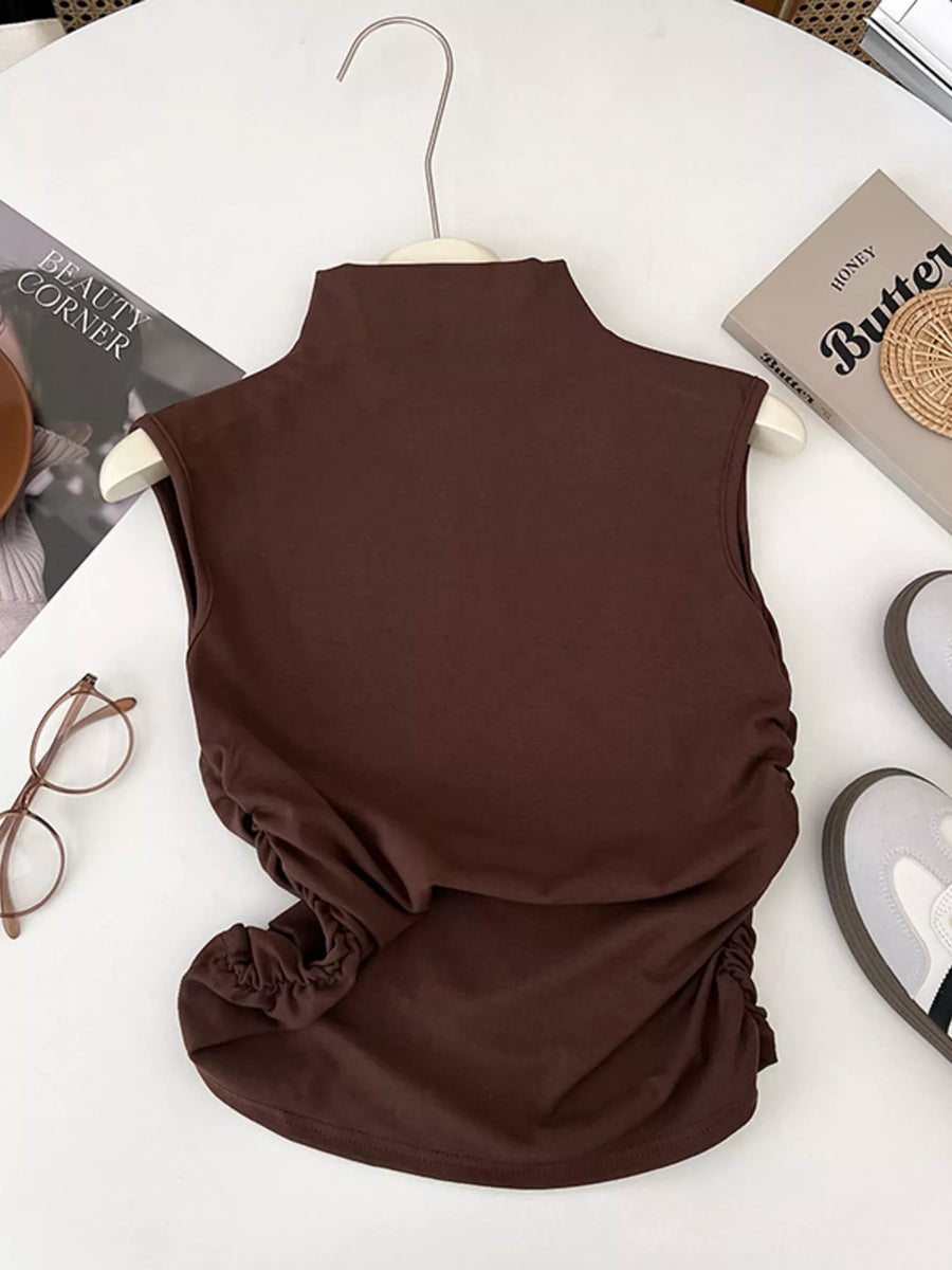 Brown sleeveless top on a hanger with a white background