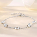 Silver bracelet with various charms on a light background