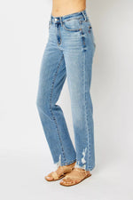 Light blue jeans worn by a person on a white background