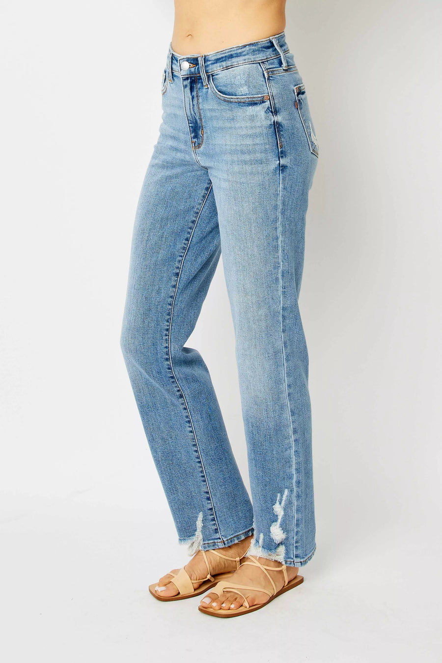 Light blue jeans worn by a person on a white background