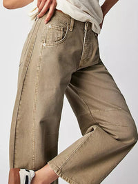 Brown pants worn by a person on a plain background