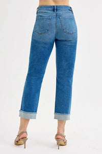 Blue jeans worn by a person on a white background