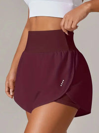 Maroon skirt worn by a person on a plain background