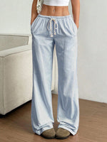 Light blue striped pants worn by a person in a minimal indoor setting