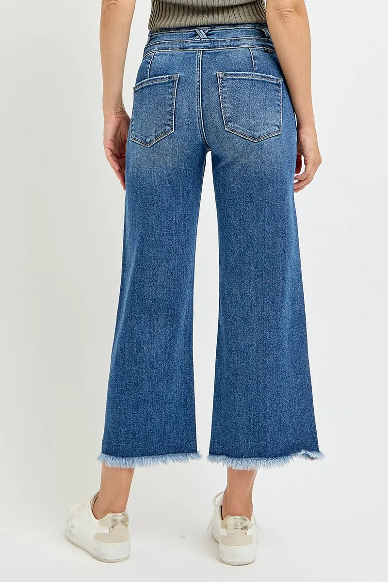 Blue jeans worn by a person on a white background