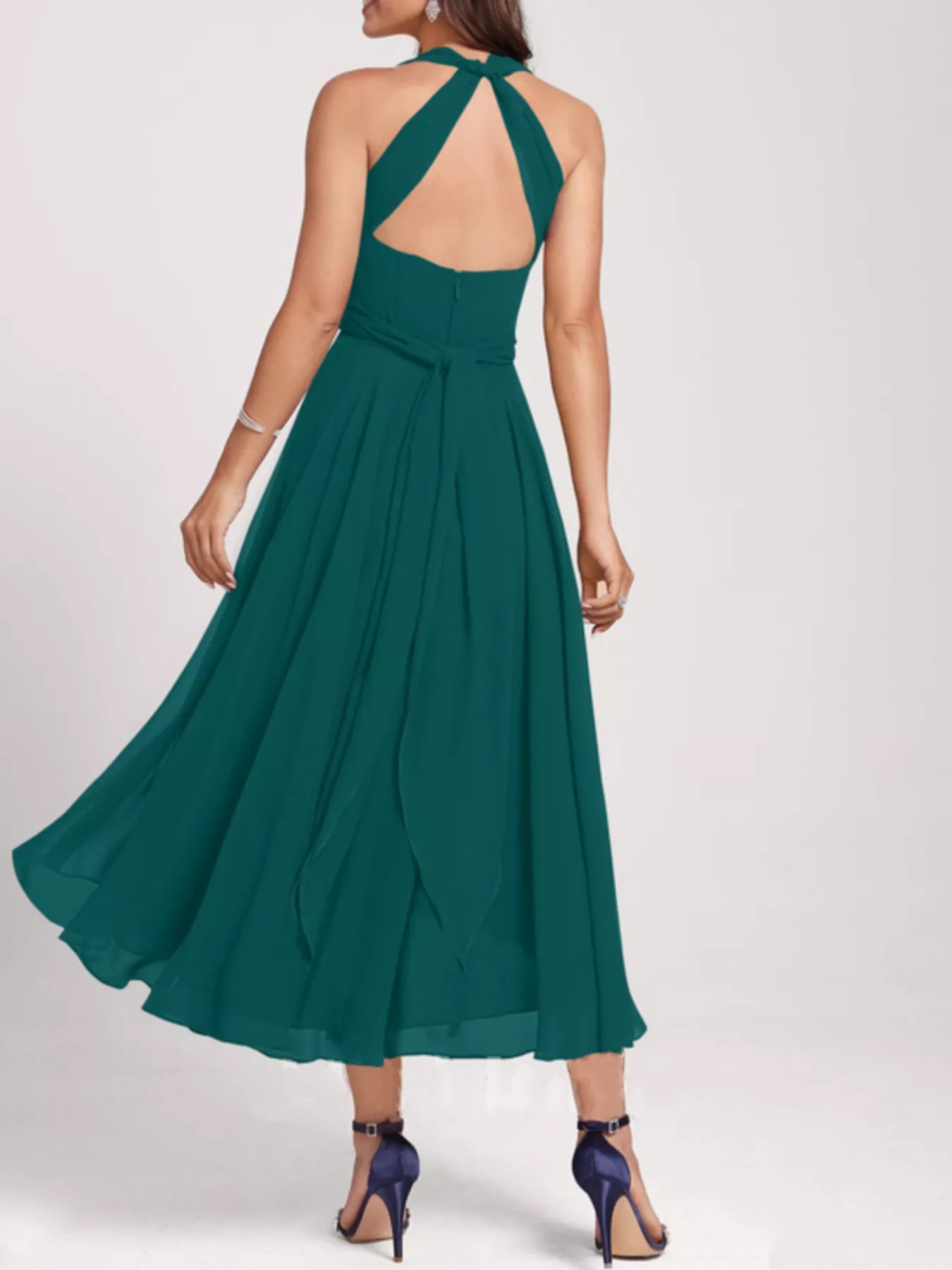 Green dress with open back on a white background
