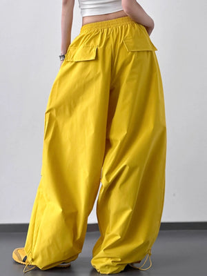 Yellow wide-leg pants worn by a person on a plain background