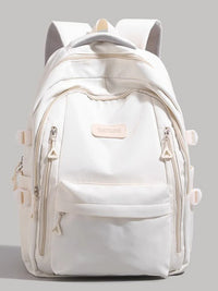 White backpack with multiple zippers on a gray background