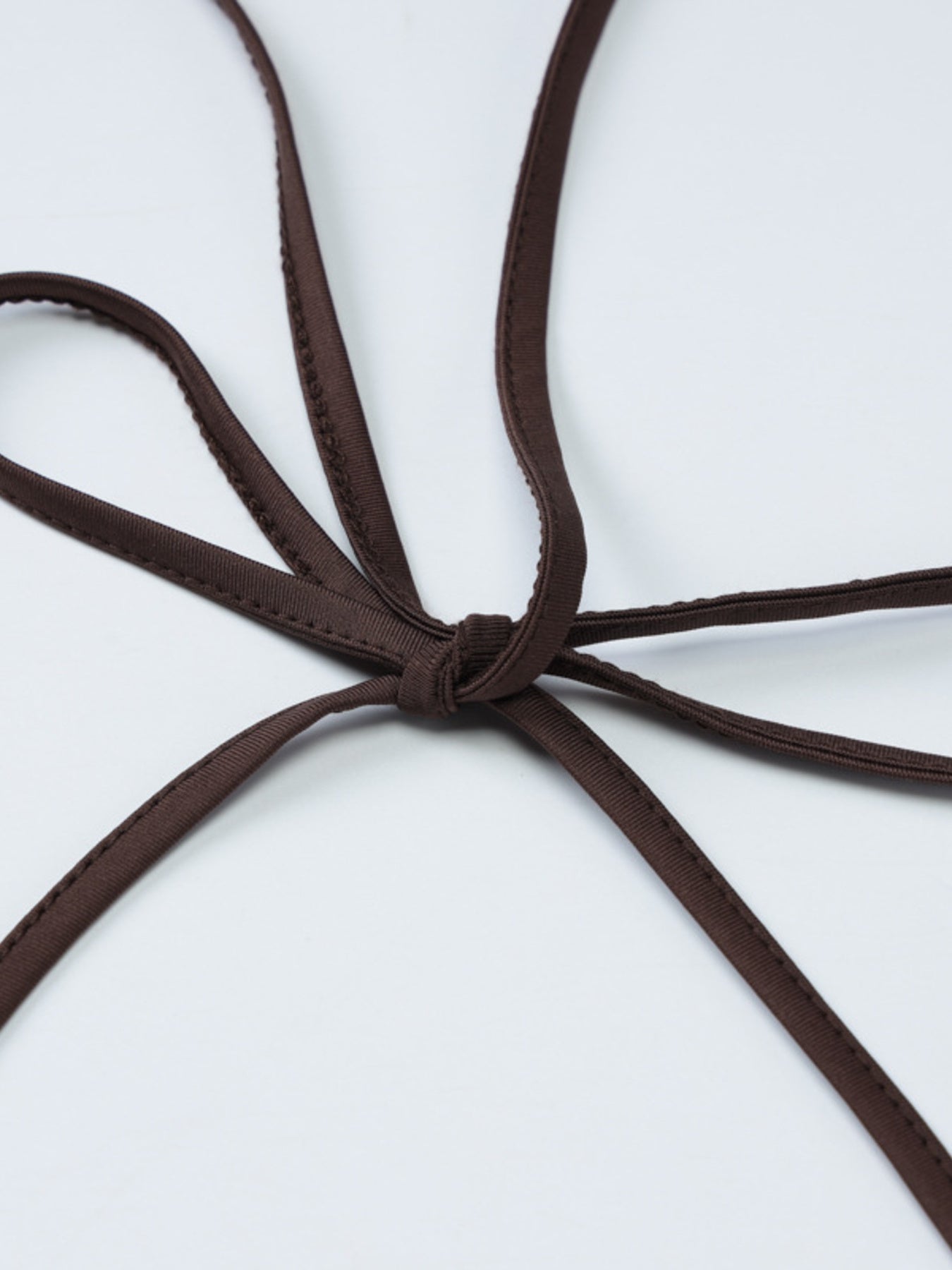 Close-up of brown shoelaces on a white background