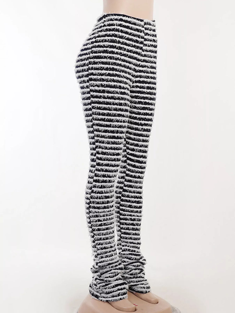 Black and white striped knit pants displayed on a mannequin leg against a plain white background.